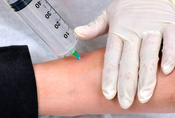 A doctor injects ozone into a patients ankle.